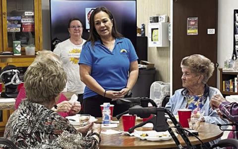 Lunch-and-learn speakers on Monday, Nov. 6 were Christy Bohuslav (standing behind table, in front) and Patti Sappington (standing behind table, in back), who discussed breathing and health.