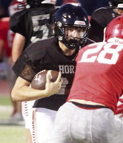 Mason Kunschick, who returns at running back, carries for 8 yards in the scrimmage last Thursday. Sticker Photo By Darrell Vyvjala