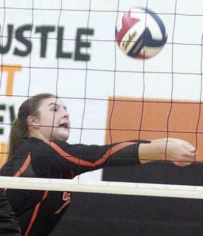 Landry Zapalac saves a ball near the net in the first set on Sept. 23. Sticker Photo By Darrell Vyvjala