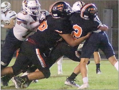 John Davis (No. 2), with help from Jose Cleto, brings down Colin Ramzinski at the line of scrimmage in the third quarter. Sticker Photo By Layne Vyvjala