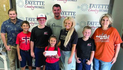 Representat ives of Fayette Country Homes and Adamek Rentals, shown with St. Rose students, are (from left) Dalton Manning, Dylan Zweschper-SRS, Bo Brossmann-SRS, Emma Zweschper-SRS, Dalton Friedrich, Hillary Adamek, Brody Brossmann-SRS and Sonjia Biddle.