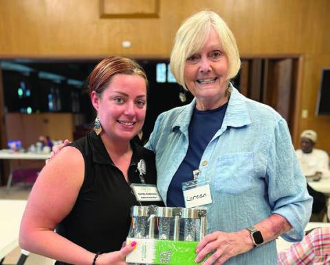Sandy Anderso n (left) of True Care Living in Columbus called bingo in Weimar and Loreen Rhodes (right) won the light set Anderson brought for a blackout prize.
