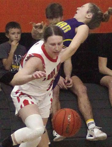 Hope Hammack cuts in front of a Ladycat for a steal in the second half Friday. Sticker Photo By Darrell Vyvjala