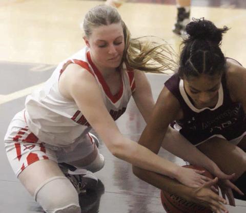 Kaylee Beyer battles for a loose ball in the fourth quarter of the game against Flatonia. Sticker Photo By Darrell Vyvjala