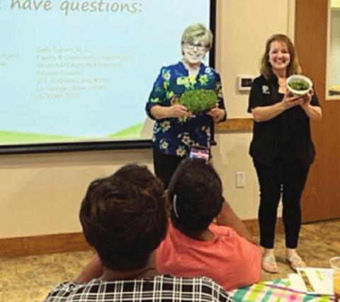 Showing their gardening efforts after presenting a session on “Nutrition, Math &amp; Science with Microgreens” at the recent Multi-County Child Care Conference are Sally Garrett (left), Fayette County agent, and Gayle Bludau (right), Gonzales County agent.