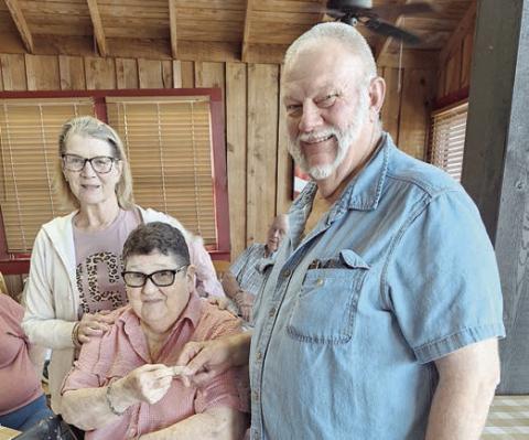 Kitty Dittrich (seated) received her 75-year pin from Mary K. Seifert (left), vice president, and Ed Moeller (right), president.