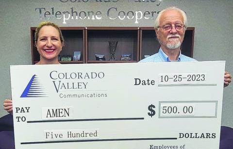 Funds donated by members of Colorado Valley Communications went given to AMEN Food Pantry. Shown are (from left) Colorado Valley Communications director of regulatory affairs and marketing Karen Gunkel and AMEN treasurer Garry Schellberg.