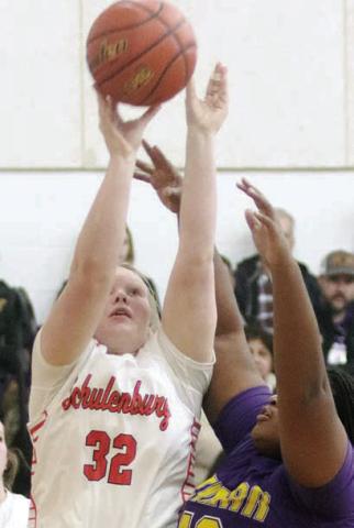 Ava Bubela scores under the basket in the second quarter last Tuesday. Sticker Photo By Darrell Vyvjala