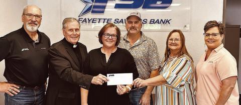 The Matching Funds Campaign at Fayette Savings Bank for St. Rose School renovations has received a $5,000 donation from Misty and Colin Ohnheiser (center). Also shown are (from left) Mike Olle, Fayette Savings Bank; Very Rev. Jasper Liggio, St. Rose of Lima Catholic Church pastor; (continuing after the Ohnheisers) Rosanne Gallia, St. Rose School principal; and Cheryl Brossmann, Fayette Savings Bank lobby manager.