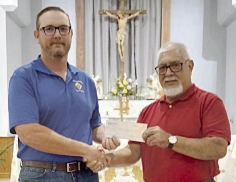 St. Rose School band director Julius Castillo (right) accepts a $500 donation to the school’s music program from Knights of Columbus Council 2902, represented by deputy grand knight Matt Bartek (left)