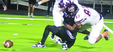 Jayvan Luhrs forces a fumble on a sack late in the second quarter. Sticker Photo By Darrell Vyvjala