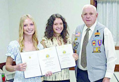 Presenting the scholarships to Alyssa Zbranek (left) and Natalie Osina (center) was Leonard Sternadel (right) representing VVA Chapter 870.