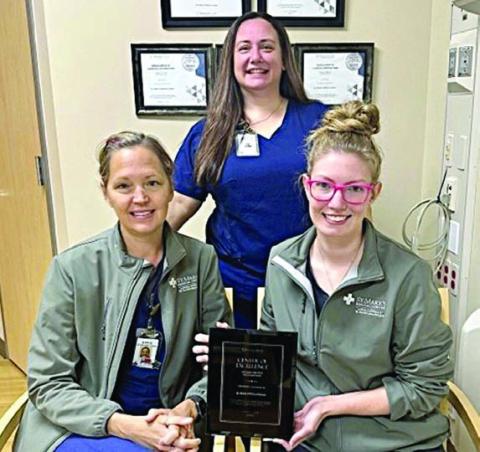 Displaying the Restorix Health clinical distinction award is the St. Mark’s Advanced Outpatient Wound Center team of (front row, from left) Stacie Schramek, RN; Jackie Faigle, FNP-C; and (back) Jennifer Scott, RN, program director. The team is one of only 26 in the US to achieve the goals in wound healing rates and safety.