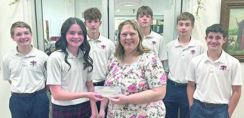 St. Rose of Lima Catholic School students raised money to donate to the Schulenburg Area Food Pantry. Charlotte Schmidt (front left), SRS eighth grader, represented the school in presenting the check to Sheila Brossmann (front right), who accepted on behalf of the Food Pantry. Other students shown are (back row, from left) Patrick Taylor, Austin Reeves, Jacob Schramek, Justin Schramek and Cal Schiffli.
