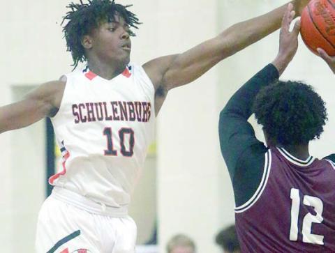 Da’Terrion Houston forces a turnover in the season opener. Sticker Photo By Darrell Vyvjala