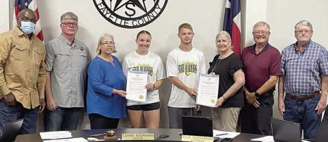 The Schulenburg City Council presents proclamations recognizing Schulenburg High School senior Mikayla Otto and sophomore Caden Herzik (center) for making the Class 2A state tennis tournament as a mixed doubles team. Shown with Otto and Herzik at Monday night’s meeting are: (from left) aldermen Greg Thomas and Frank Wick III, Mayor Connie Koopmann; and (from right) aldermen Clarence Ahlschlager, Roger Moellenberndt, and Kathy Kleiber. Sticker Photo By Darrell Vyvjala