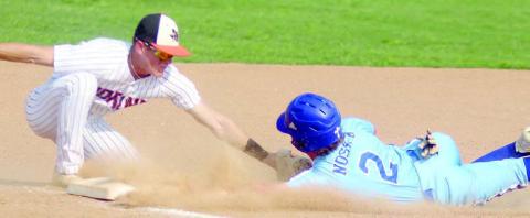 Third baseman Reid Janda tags an Indian for an out in the Horns’ 3-2 win. Sticker Photo By Darrell Vyvjala