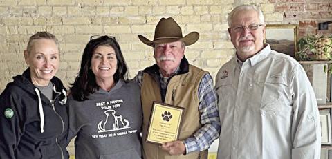 Tom Zapata of Schulenburg (second from right) received a plaque recognizing his contributions to the Gardenia E. Janssen Animal Shelter. He is shown with (from left) April Pierson, director; Teresa Brown, executive director; and (right) Frank Reichert, board of directors president.