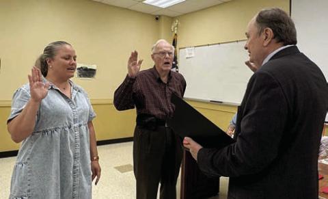NEW Executive COMMITTEE MEMBERS SWORN IN – Christyna Fitzpatrick (left) and Arnold Romberg (center) were sworn in as newly elected executive committee members by Dan Mueller (right).