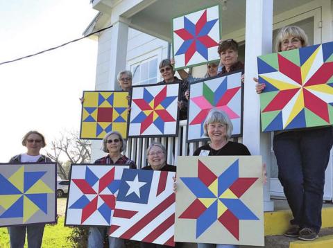 Students in a quilt block painting class in Winchester display their creations. A similar class will be held Friday at the Blinn College-Schulenburg Campus.