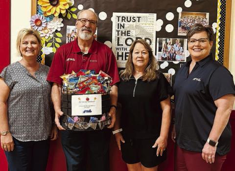 Presentation at St. Rose of Lima Catholic School – (from left) Jeannie Mican, administrative assistant; Mike Olle, FSB; Sandy Zaruba, athletic director; and Cheryl Brossmann, FSB.