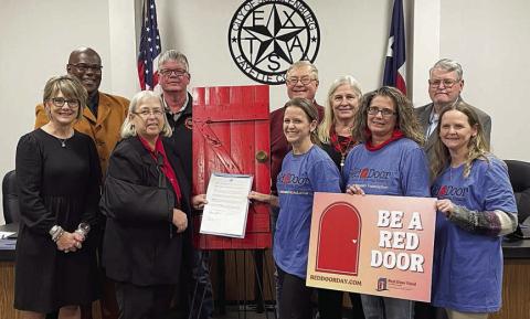 On hand at last week’s meeting for the Schulenburg City Council’s proclamation in support of “Red Door Day” were: (front, from left) City Administrator Tami Walker, Mayor Connie Koopmann, Cheryl Pekar, Vickie Hudec, Christina Mulholland; (back, from left) aldermen Greg Thomas, Frank Wick III, Roger Moellenberndt, Kathy Kleiber, and Clarence Ahlschlager. Sticker Photo By Darrell Vyvjala