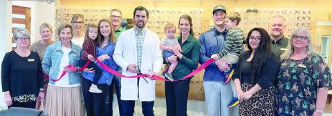 Shown are (from left) Nina Howard, Carrie Schulz, Diana Mikesky, Renee Mikesky, Aubrey Hentges being held by Shannon Hentges (optician at the clinic), Shawn Mikesky, Dr. Kaden Andre, Brady Andre being held by Dr. Leah Mikesky, Hale Hentges holding Ezra Hentges, Amanda Blackburn (front desk staff at the clinic), Paul Zapalac and Ann McBride. Sticker Photo By Darrell Vyvjala