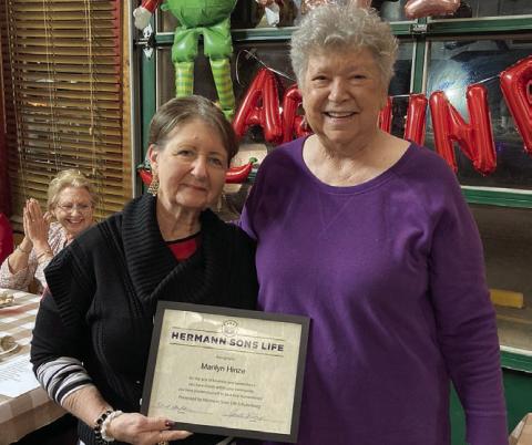 Marilyn Hinze (left) accepts the Humanitarian of the Year Award from Junette Rodecap, who serves as chair of the award committee for Hermann Sons Life.
