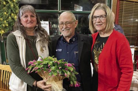 A plant is being presented by Lodge 14 vice president Mary K. Seifert (right) to Hermann Sons Life Grand Lodge board member David Noak (center) for coming to present the pins. Also shown is Noak’s guest Theresa Garlin (left).