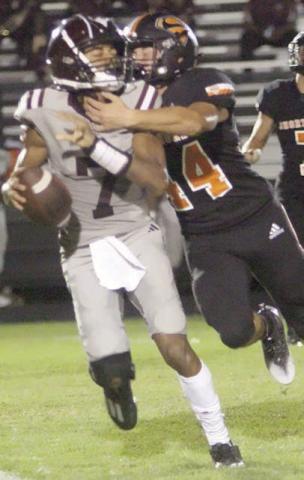 Aiden Mendez forces an intentional grounding with his quarterback pressure in the second quarter. Sticker Photo By Layne Vyvjala