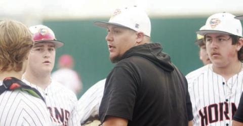 Head coach Marty Bigham (center) chats with his players between innings during a tournament game last week. Sticker Photo By Darrell Vyvjala
