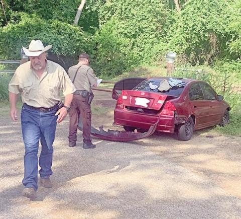 Sheriff Keith Korenek and Deputy Michael Krenek are shown with the vehicle involved in Monday’s pursuit.