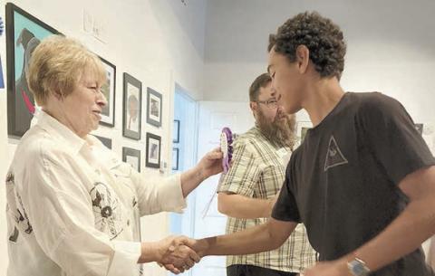 2022 Best of Show Winner in the ARTS Emerging Artists Competition was Phoenix Kooper (foreground, right), being congratulated by Karen Vernon (left), ARTS executive director.