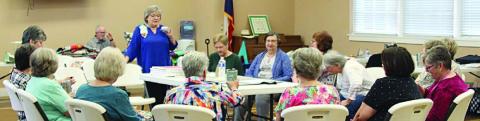 TOP PHOTO – Annie McHugs conducting a Picture Windows Reverse Applique workshop for the Colorado Valley Quilt Guild. 