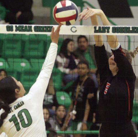 Brooke Redding rejects a Lady Eagle tip in game two. Sticker Photo By Darrell Vyvjala