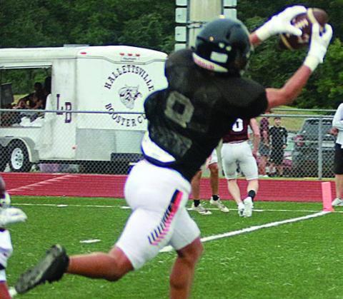 Denver Carr snatches the ball out of the air on a slant for a 7-yard touchdown reception against Hallettsville. Sticker Photo By Darrell Vyvjala