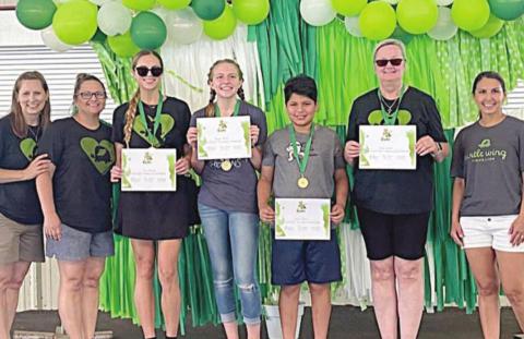 FUN RUN WINNERS – (from left) DeeAnn Hooper (Turtle Wing Foundation founder), Kim Wellborn (Turtle Wing Foundation Board member), Kari Cristen (Women’s Division winner), Reagan Moreau (Girls’ 17u Division winner), Lucas Moreno (Boys’ 17u Division winner), Becky Garlick (Not Fast, But Fabulous Award), and Kari Tumis (Turtle Wing Foundation Board member).