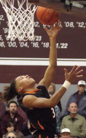 Byron Johnson scores on a layup in the first quarter against Flatonia. Sticker Photo By Darrell Vyvjala