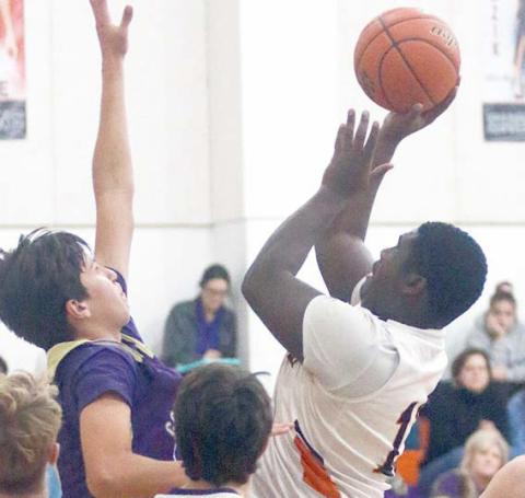 Tavondrick Ellison scores in the lane after an offensive rebound in the second quarter against Shiner. Sticker Photo By Darrell Vyvjala