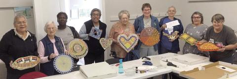 On Mosaic mania photo day, nine members were present to show off the mosaic art they created – (from left) Polly Quinones, Helen McIntyre, Alfreda Ellison, Cindy Villarreal-director, Irene Janda, Berni Gillings, Mary Bellinger, Carolyn Moore and JoNell Vacek.
