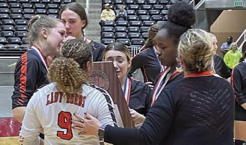 Kieryn Adams (No. 9) with fellow seniors (from left) Brooke Redding, Meredith Magliolo, Keaton Walker, and Jessalyn Gipson accept the state semifinal trophy from High School Principal Callene Zapalac. Sticker Photo By Darrell Vyvjala