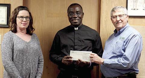 Members of Fayette Electric Cooperative gave donations to be presented to the Holy Rosary Church Building Fund in conjunction with the Document Shred Day. Shown are (from left) FEC marketing and training coordinator Tracy Denton, Holy Rosary Church parochial administrator Fr. Felix Twumasi, and FEC General Manager Gary Don Nietsche.
