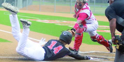 Connor Lichnovsky get his right hand to home plate ahead of the tag to score in the top of the first inning of game one. Sticker Photo By Darrell Vyvjala