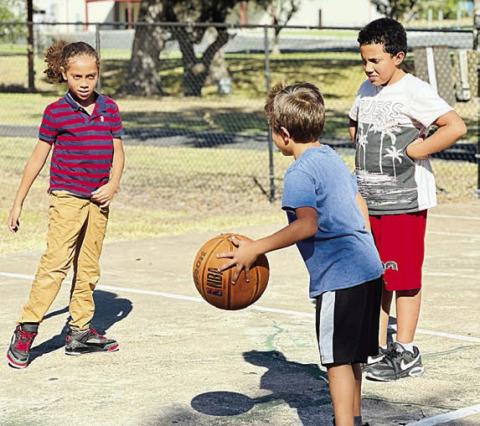 A favorite program for Boys & Girls Club members at the Schulenburg Unit is Triple Play because it involves playing fun and active games such as Hoop Defenders. Shown are (from left) Club members Joshua Villanueva, Valdemar Pineda and Kayden Kehoe.
