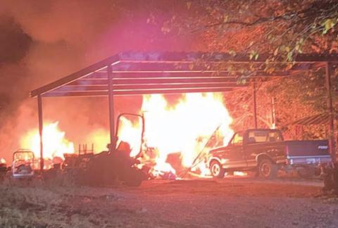 A early-morning fire engulfed two structures on Camp Lone Star Road in La Grange Sunday. Photo Courtesy of Fayette County Sheriff’s Department