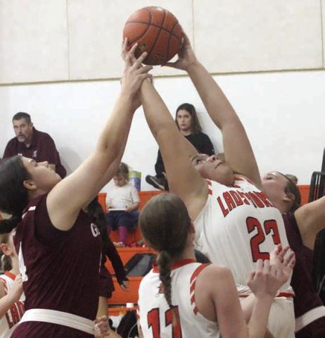 Arianna Vincent pulls down an offensive rebound against Ganado in the second half. Sticker Photo By Darrell Vyvjala