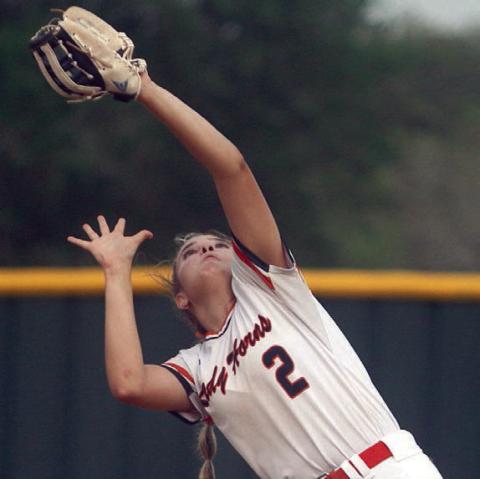First baseman Audrey Woytek gathers in a Maiden popup. Sticker Photo By Darrell Vyvjala