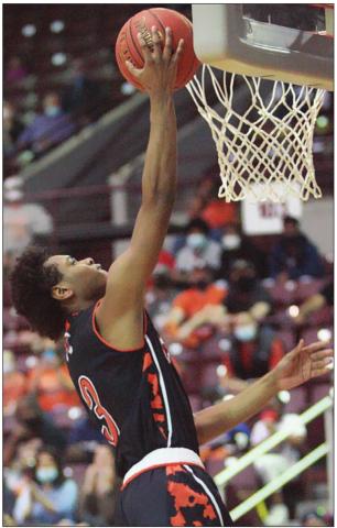 Bryce Wilson soars to the hoop for a score in the third quarter. Sticker Photo By Kade Vyvjala