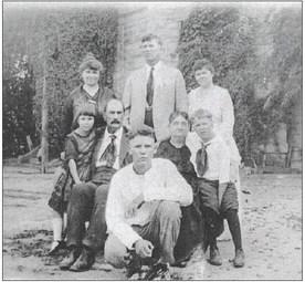 Loessin family at Fayette County Jail, circa 1919. Standing are Katie (Stiehl) Loessin, Will Loessin, and an unidentified woman. Seated are Ruth, August and Louise Loessin, and an unidentified young boy. In front is Wilburn Loessin. Photo Courtesy of Fayette Heritage Museum &amp; Archives
