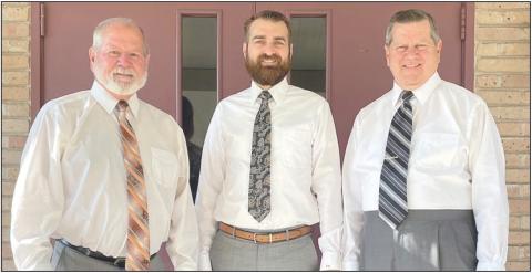Shown in front of Schwenke-Baumgarten Funeral Home are (from left) Mark, Clayton, and Bryan Klesel. Sticker Photo By Darrell Vyvjala